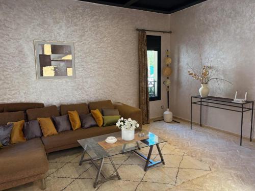 a living room with a couch and a table at Riad Perles d'Annellia in Marrakech