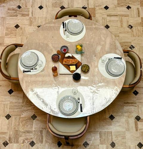a table with plates of food on top of it at Riad Perles d'Annellia in Marrakech
