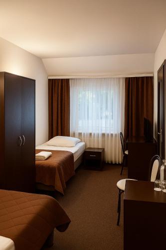 Ένα ή περισσότερα κρεβάτια σε δωμάτιο στο Hotel Junior 2