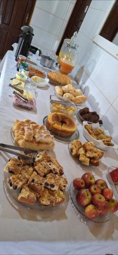 a table full of different types of pastries and pies at Pousada Alma Jalapoeira - Mateiros in Mateiros