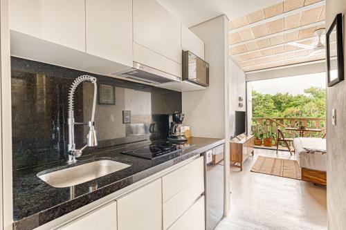 a kitchen with a sink and a counter top at Fabulous Loft With Pool in Cancún