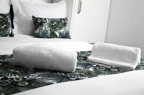 a bed with two towels sitting on top of it at stuDio57 11 in Alexandroupoli