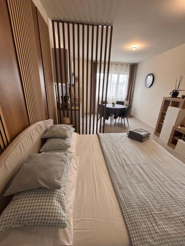 a bedroom with two beds and a dining room at Casa Bella Luna in Bergamo