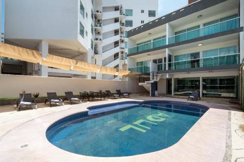 a swimming pool in front of a building at Villas Acapulco Punta Diamante in Acapulco