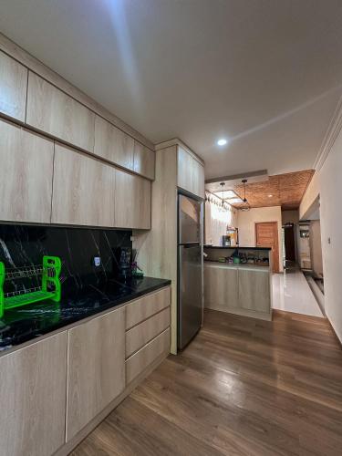 a kitchen with wooden cabinets and a counter top at Dejaviews Resort in Singaraja