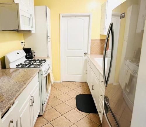 a kitchen with a stove and a refrigerator at Los Angeles Home Located in Beautiful Pasadena in Pasadena