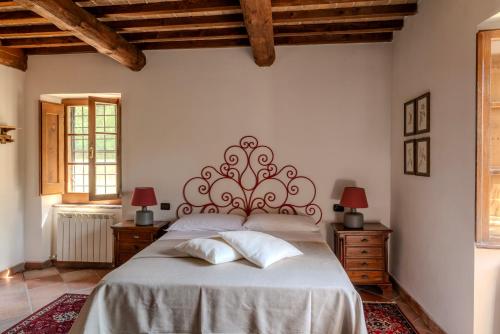 a bedroom with a large bed with two night stands at Charming&Luxury Villa near Assisi, Service Experience Exclusive in Valfabbrica