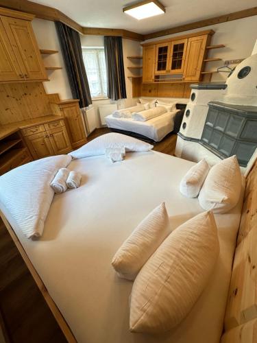 a large white bed in a room with pillows at Deluxe Apart Bader in Ehrwald