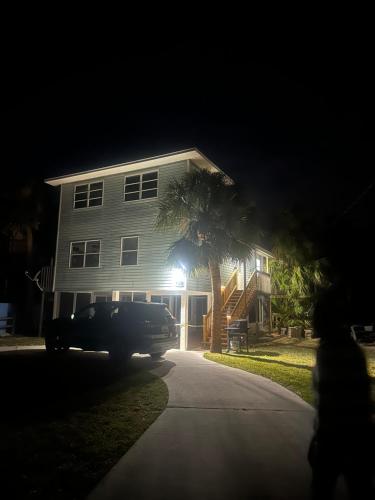 a truck parked in front of a house at night at Beachfront House Pine Island, Tampa, Orlando in Weeki Wachee