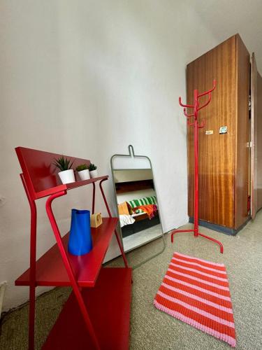 a room with a red cabinet and a red rug at NUMBR25 - self service & low budget Hotel in Graz