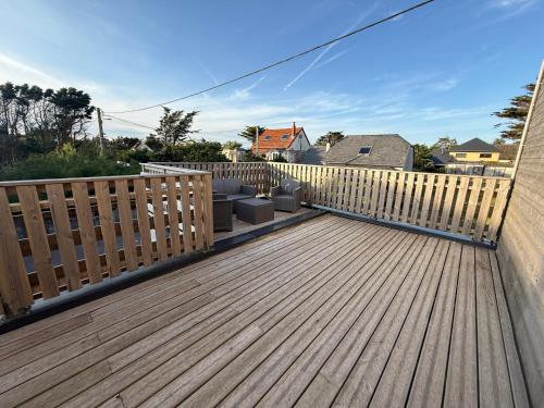 a wooden deck with a fence on a house at Beach House in Port-Bail-sur-Mer