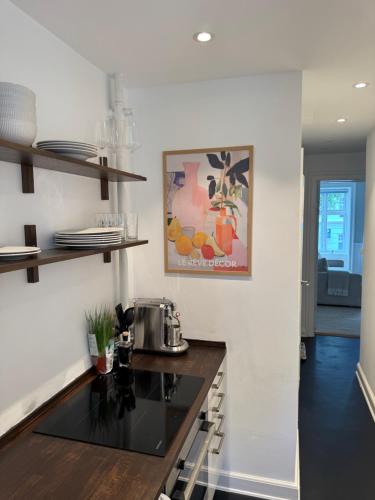 a kitchen with a sink and a counter top at Stylish Apartment with Rooftop in Trendy Vesterbro in Copenhagen