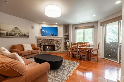 a living room with a couch and a table and a fireplace at Strawberry Park Condos feature Ski-In Ski-Out and Outdoor Heated Pool condo in Beaver Creek