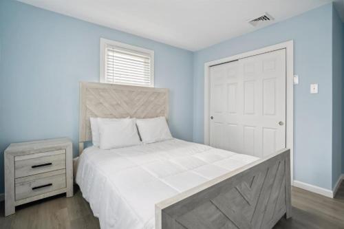 a bedroom with a white bed and a white door at 110 E 24Th Ave, Unit C in Wildwood