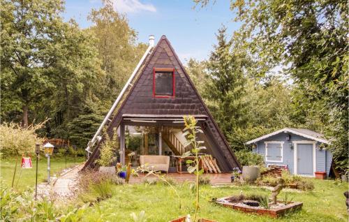 a small house with a thatched roof at Lovely Home In Kerschenbach With Wifi in Kerschenbach