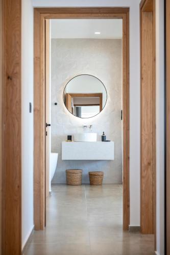 a bathroom with a sink and a mirror at Mousonas Luxury Living in Kámpos