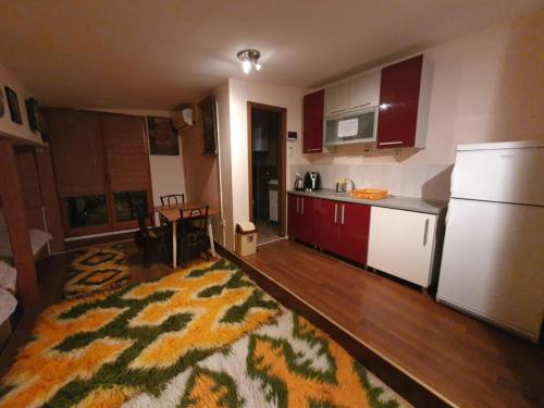 a kitchen with red cabinets and a white refrigerator at Terasa LIDO in Skopje