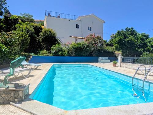 a swimming pool in the backyard of a house at Vila da Fonte - Peaceful 3-bedroom Villa with Private Pool, Central Portugal in Figueiró dos Vinhos