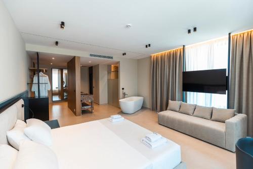 a large living room with a couch and a television at Green Light Hotel in Ksamil