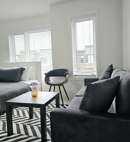 a living room with a couch and a table at SPRUCE Private Suite with attached Full Bathroom in Toronto, Canada in Toronto
