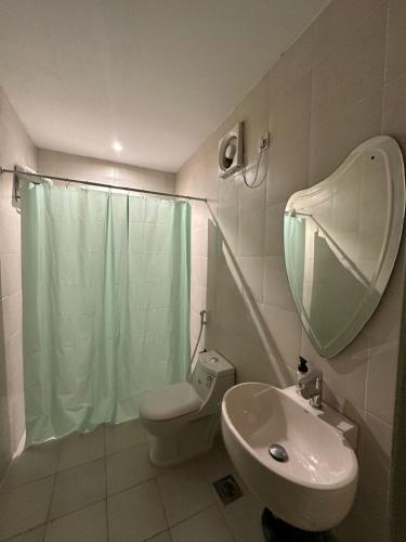 a bathroom with a sink and a toilet and a mirror at Quiet Zoon in Jeddah