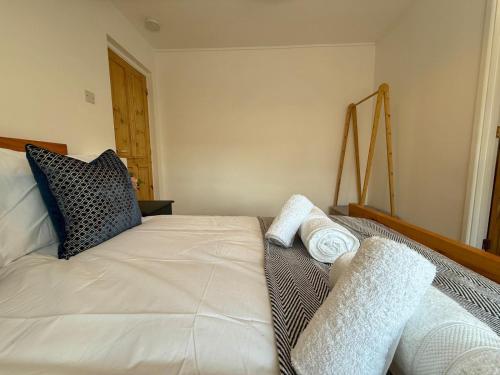 a bedroom with a bed with two towels on it at 2 bed Elegant Flat in Stansted with parking in Stansted Mountfitchet