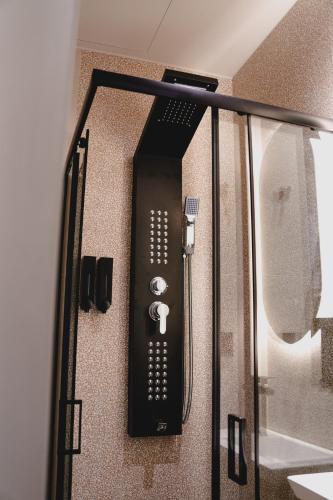 a black appliance is hanging on a wall at Centre Ville Local Stays in Argos