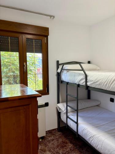 a room with two bunk beds and a counter at La Mermellina, 20 in Arriondas