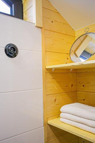 a bathroom with a white towel on a shelf at Chalet pod Strážovom in Zliechov