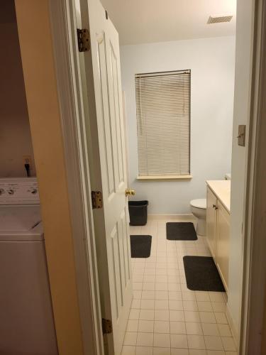 a white bathroom with a toilet and a window at Cara Drive Room in Springdale