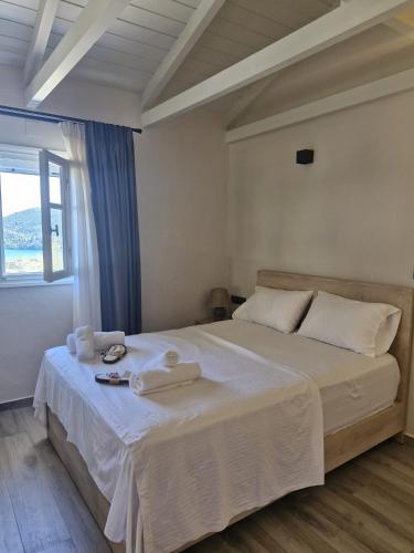 a bedroom with a large bed with towels on it at Blue Horizon Rock in Nydri