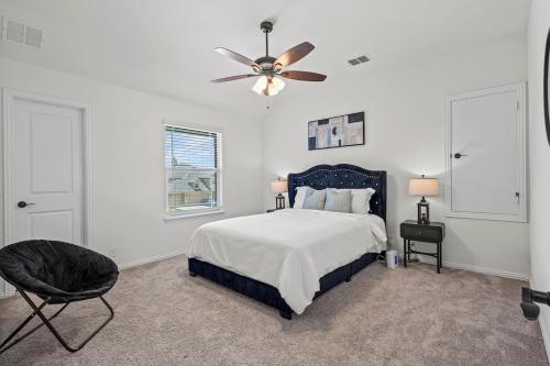 a bedroom with a bed and a ceiling fan at Rooftop Bliss 4BR with Crib Office space Fast Wifi Free Parking in Mesquite