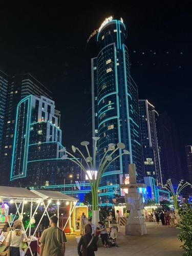 a city skyline at night with a tall building at Sea View Apartment in Batumi, Georgia in Angisa
