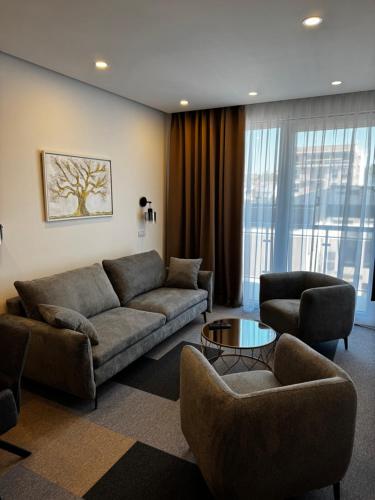 a living room with a couch and chairs and a table at Aura in Loznica