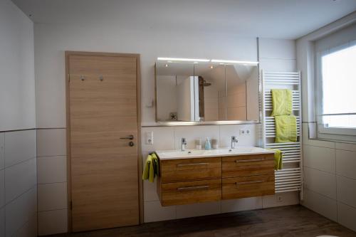 un baño con lavabo y espejo en Ferienwohnungen Kaiser, en Höchenschwand