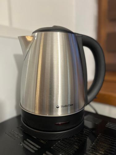 a tea kettle sitting on top of a stove at S-HOUSE Avrig Apartament Spațios cu Terasă Privată lângă Sibiu in Avrig