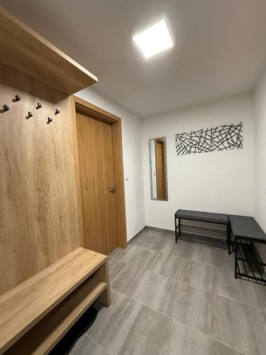 an empty room with a door and a bench at Apartmán Vlčice Residence 107, Pec pod Sněžkou in Pec pod Sněžkou