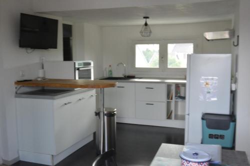a kitchen with white cabinets and a counter top at Appartement modulable in Lannemezan