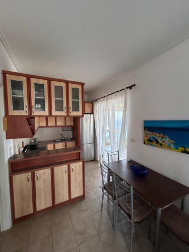 a kitchen with a table and a dining room at The Big Blue in Gythio
