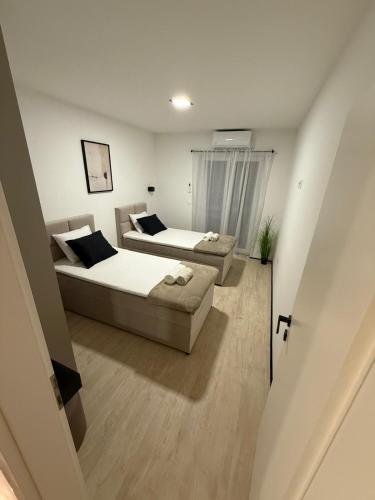 a living room with two beds and a couch at Casa Verde in Donji Zemunik