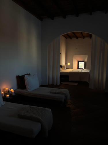 a hotel room with two beds and a window at Hospedería Convento de la Parra, 06176 in La Parra