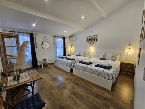 a large bedroom with two beds and a table at Esplanada do Ilhéu in Vila Franca do Campo