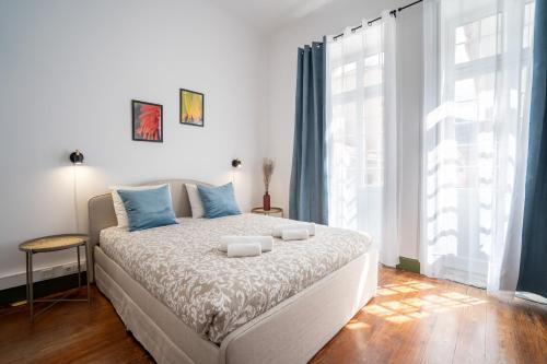 a bedroom with a bed and a large window at Zarco Suites by Sé Funchal in Funchal