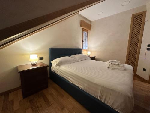 a bedroom with a large bed and two night stands at Casa Vacanza Encanto in Roccaraso