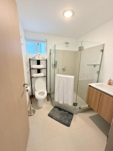 a bathroom with a shower and a toilet and a sink at Viva Jaco Unit 0605 in Jacó