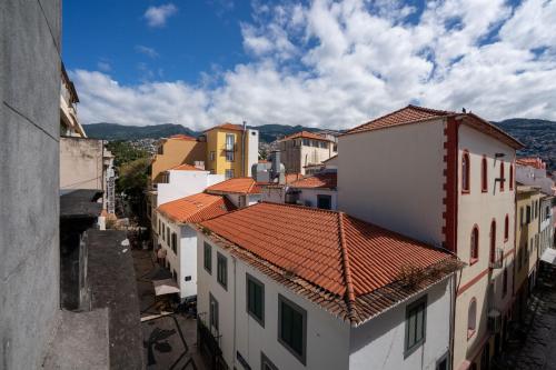 an aerial view of a city with buildings at Zarco Suites by Sé Funchal in Funchal