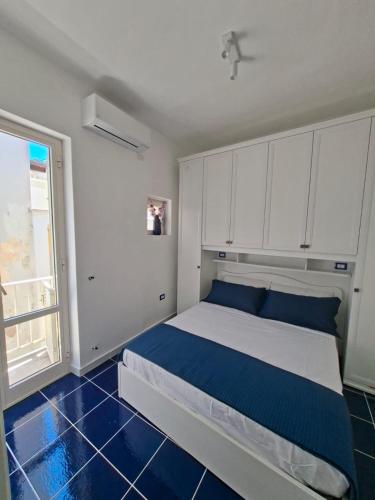 a bedroom with a large bed and a window at Bella Blu in Gaeta