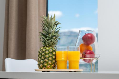 a tray of fruit and glasses of orange juice at Samstag Split in Split