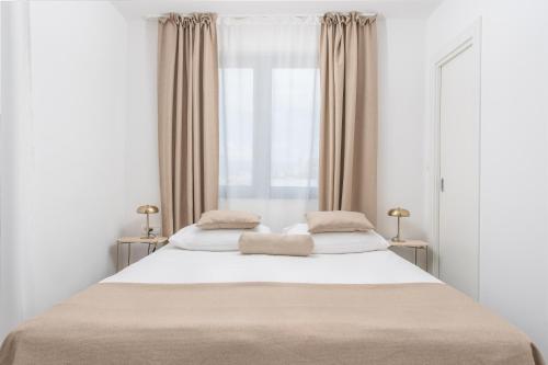 a bedroom with a large bed with two pillows on it at Samstag Split in Split