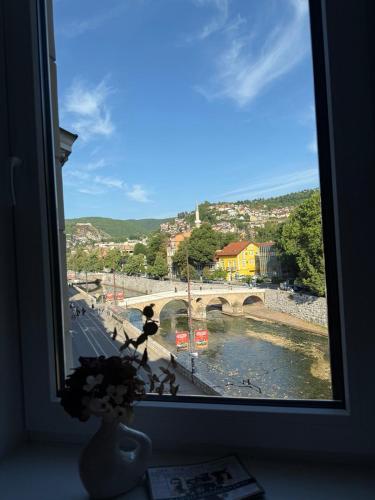 a window with a view of a bridge and a river at Latin Bridge Residence in Sarajevo